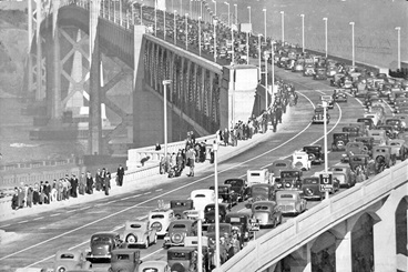 Spectators and automobile parade celebrating opening day of the San Francisco-Oakland Bay Bridge – Nov. 12; 1936.